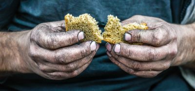 dirty hands holding bread