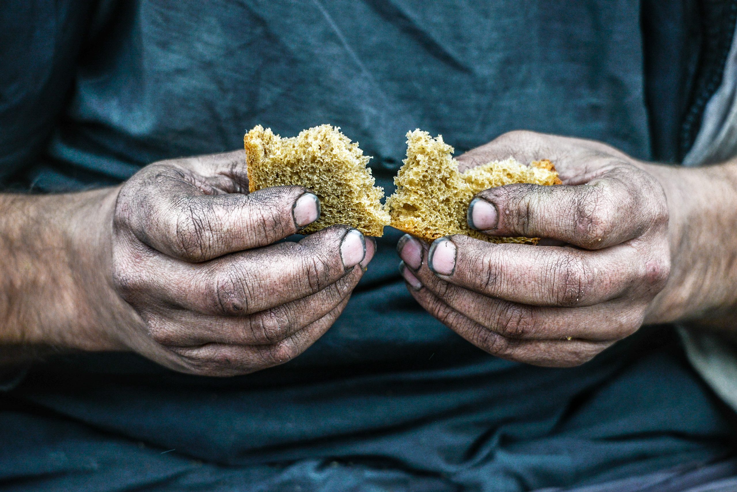 dirty hands holding bread