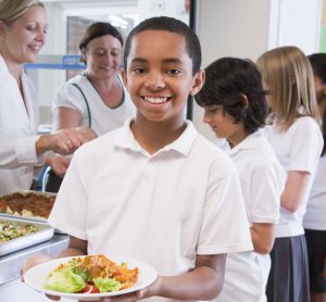 child holding school meal