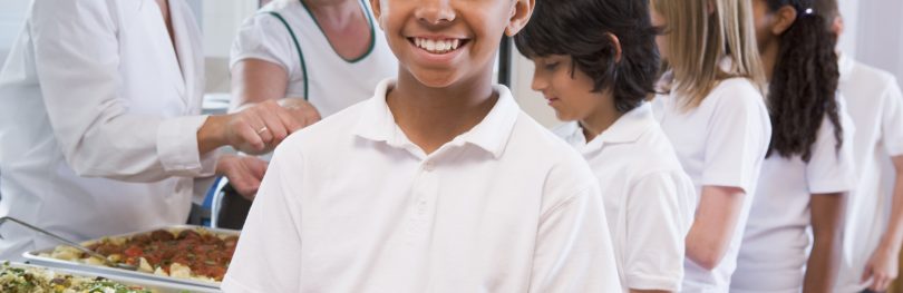 child holding school meal