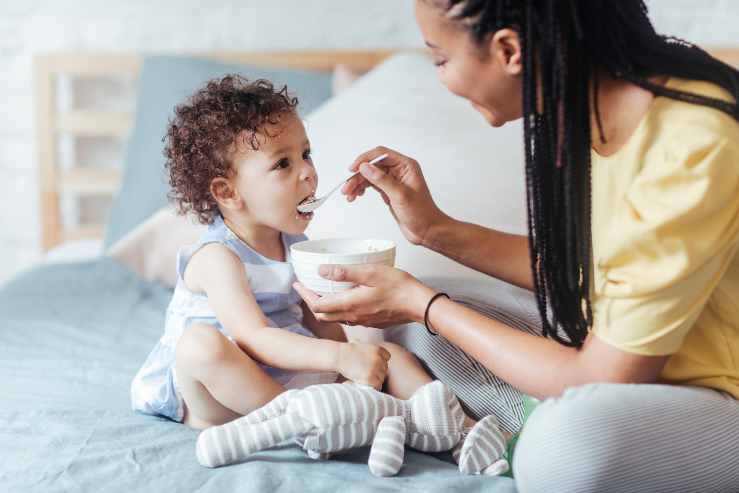 mum feeding toddler