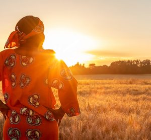 female farmer looking out over her farm in Africa