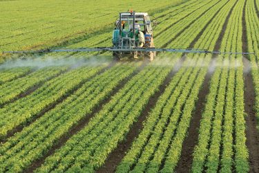 Spraying pesticides on a field